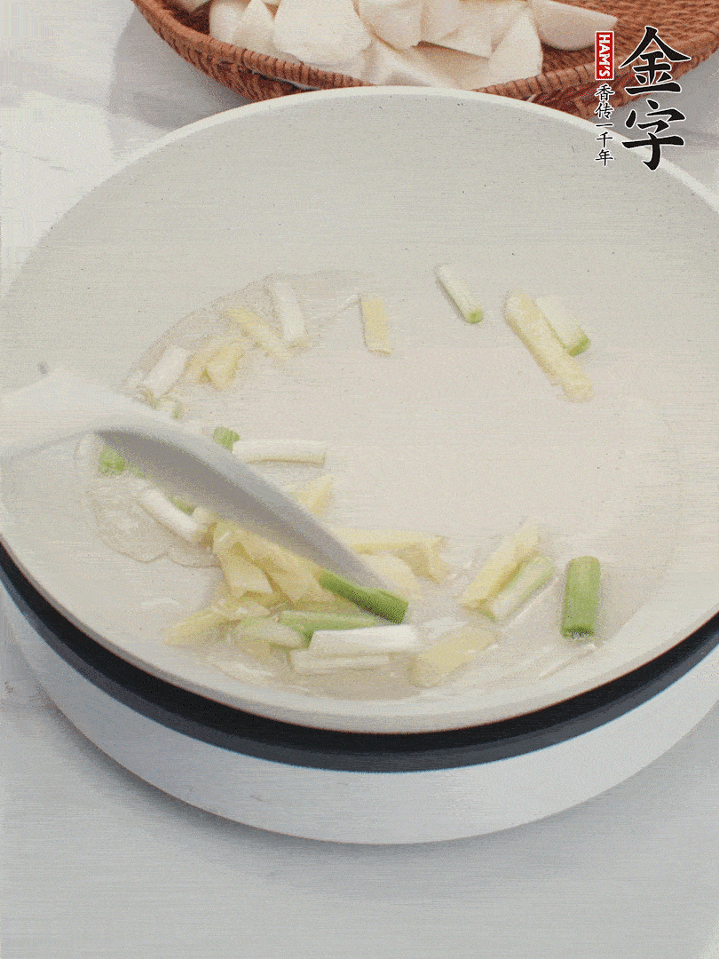 鍋中油五成熱，下蔥白、姜片爆香。